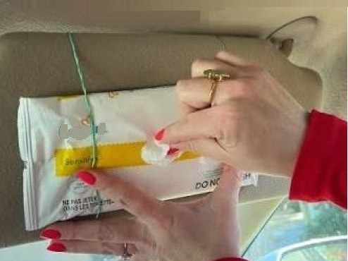 Wipes strapped to a car sun visor